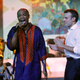 French President Emmanuel Macron (R) stands on stage as Nigerian musician Femi Kuti performs during Macron’s visit to the Afrika Shrine.